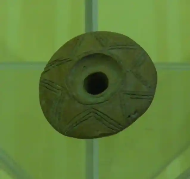 Solar symbol on a clay with hole in the center